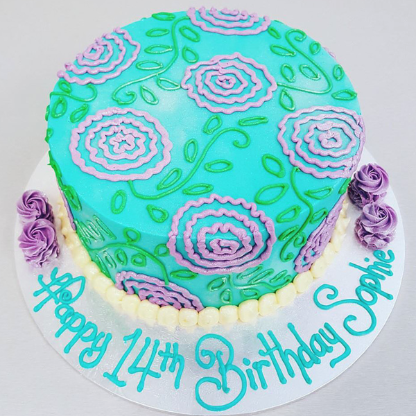 Teal Cake with Piped Purple Flowers